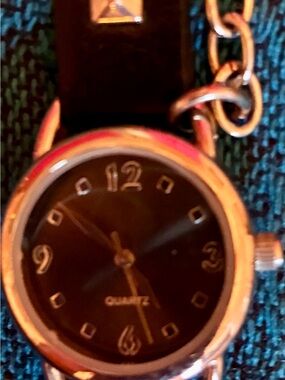 Black band watch with silver studs on band and chains